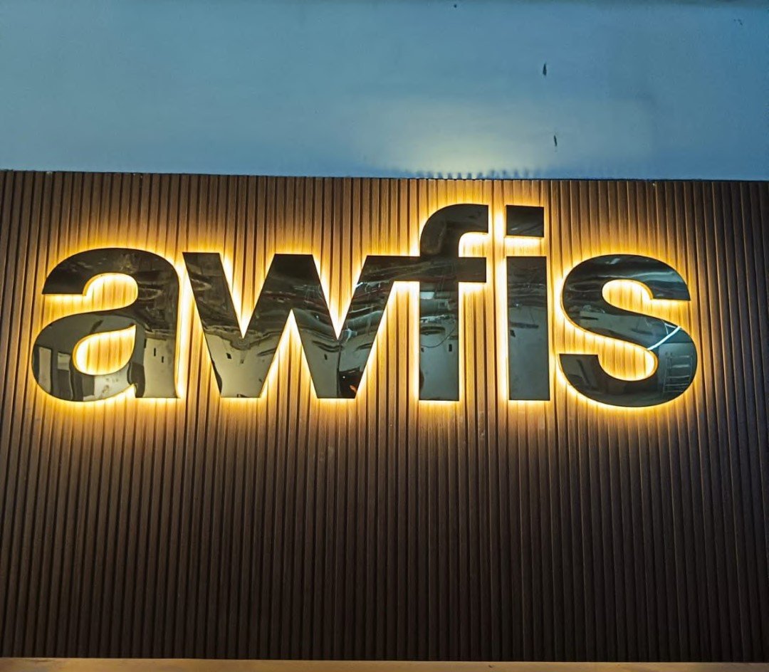 Backlit channel-letter signage for Awfis, lit at night
